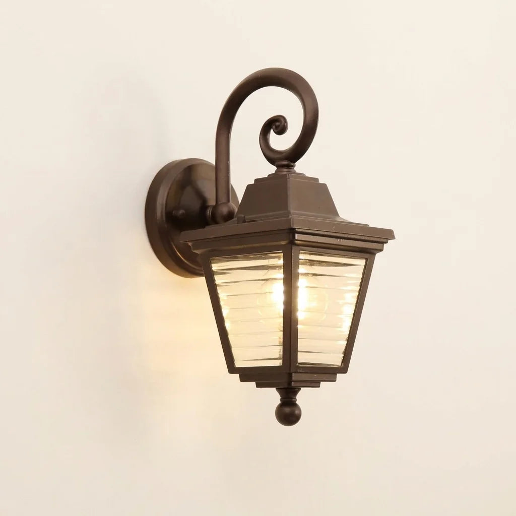 Applique extérieure lanterne à volute brun café et verre strié, allumée