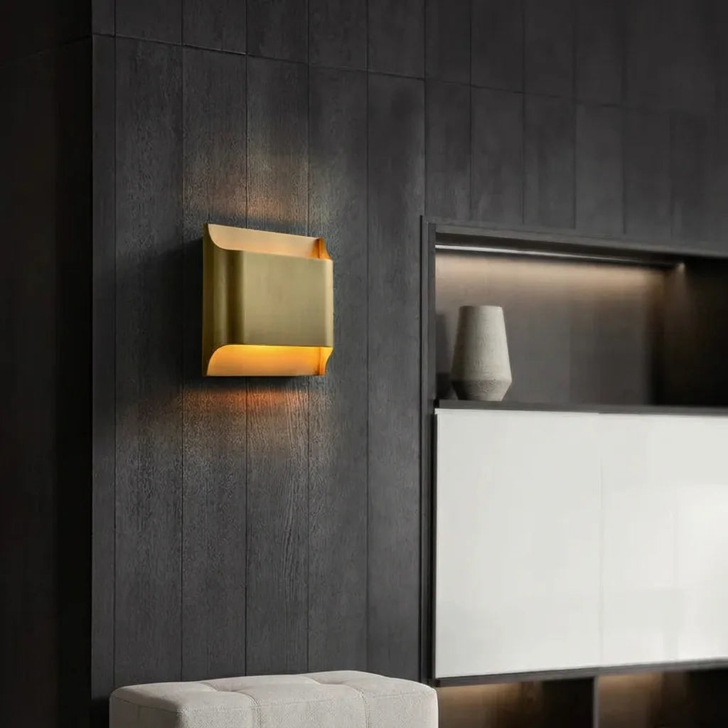 Applique carrée en laiton sur un mur en bois sombre dans un salon