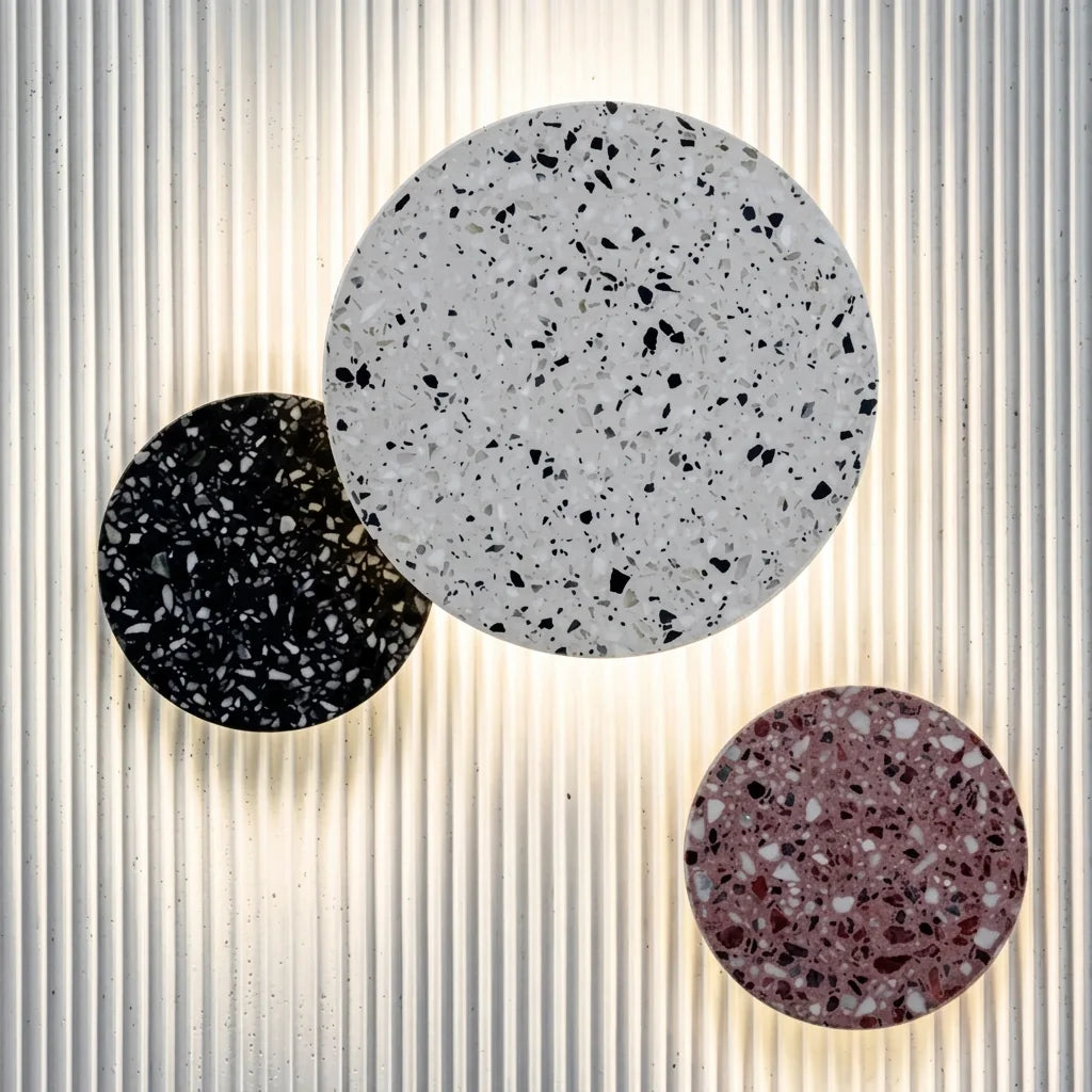 Trois appliques disque en terrazzo sur un panneau cannelé blanc
