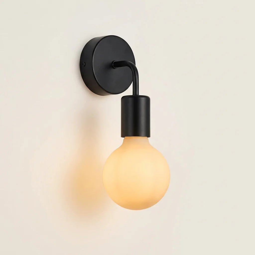 Applique murale minimaliste en métal noir et ampoule globe, allumée