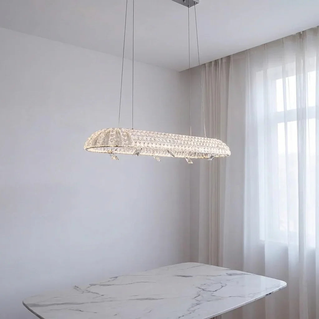Lustre ovale en cristal au-dessus d’une table en marbre