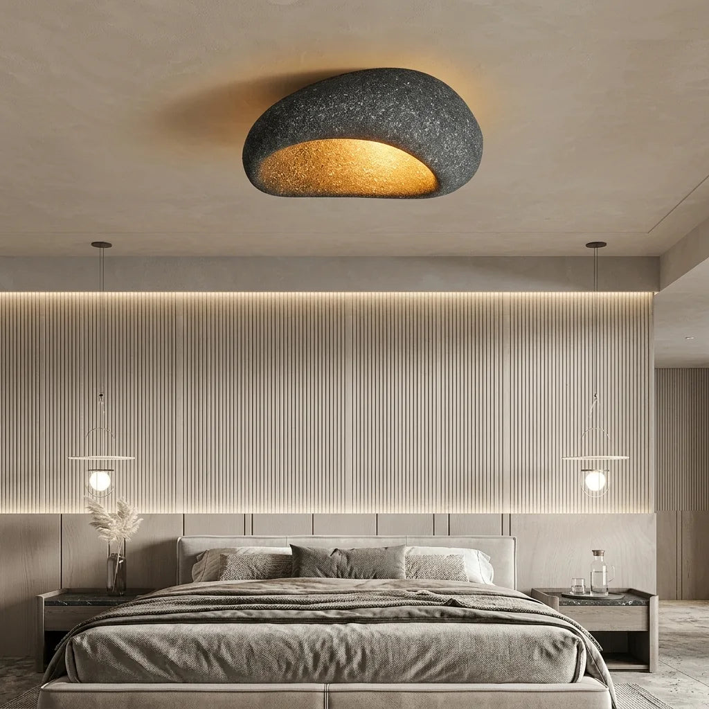 Plafonnier galet béton anthracite dans une chambre
