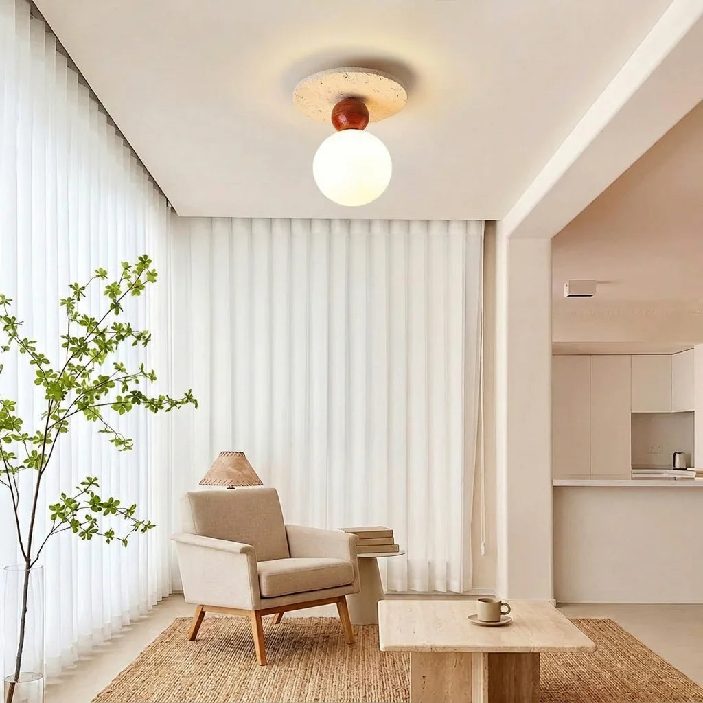 Plafonnier en travertin à un globe dans un salon clair