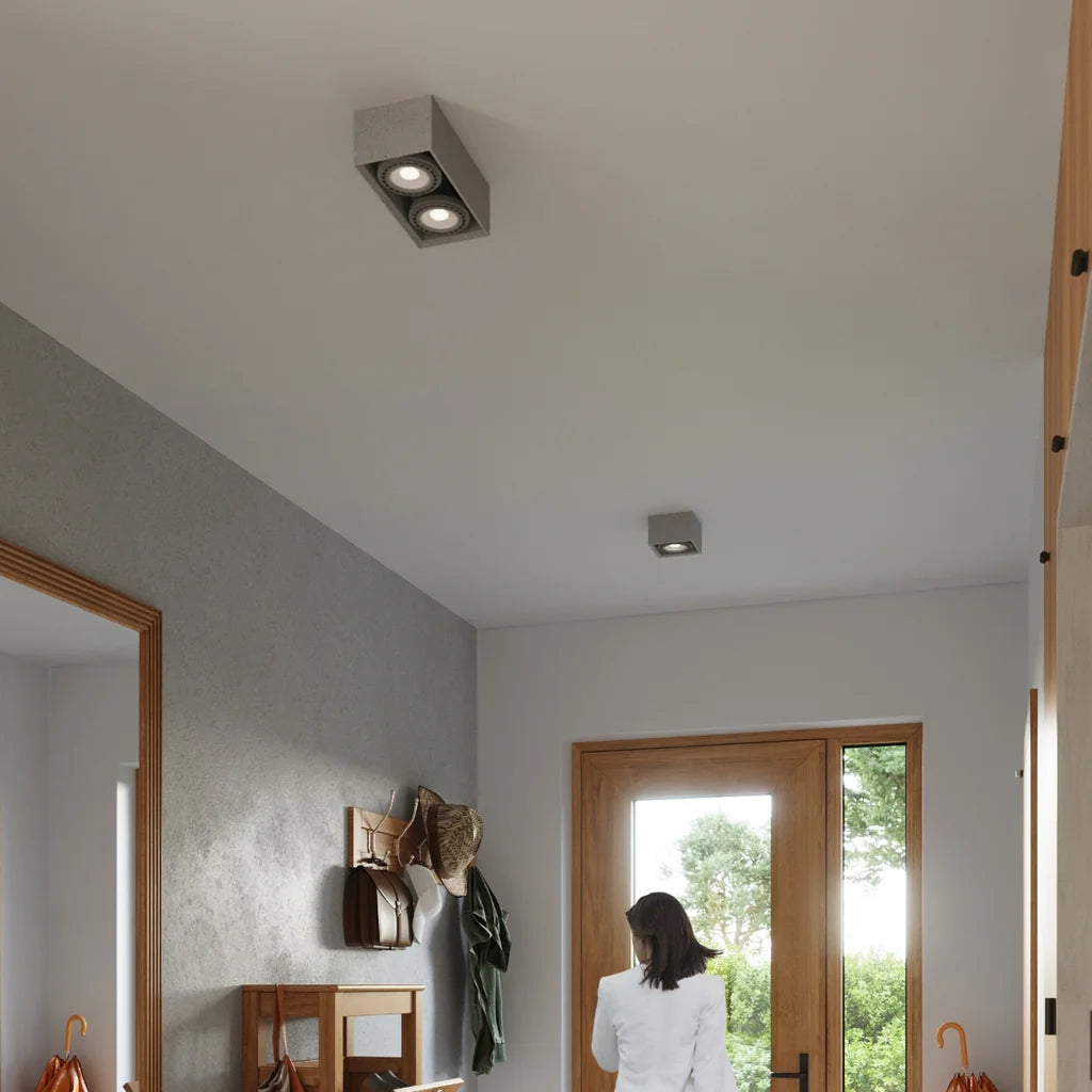 Spot plafond carré en béton dans une entrée