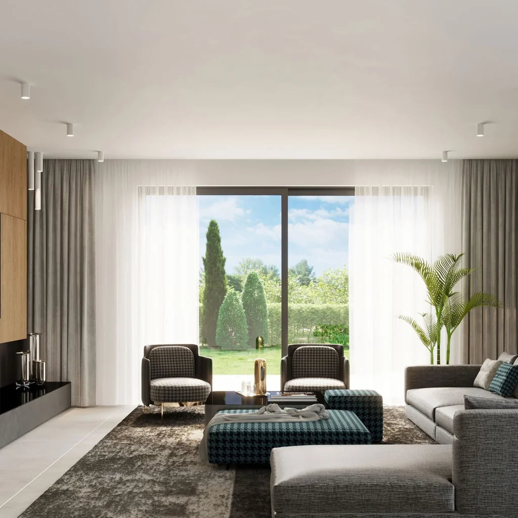 Spot plafond tube en saillie dans un salon