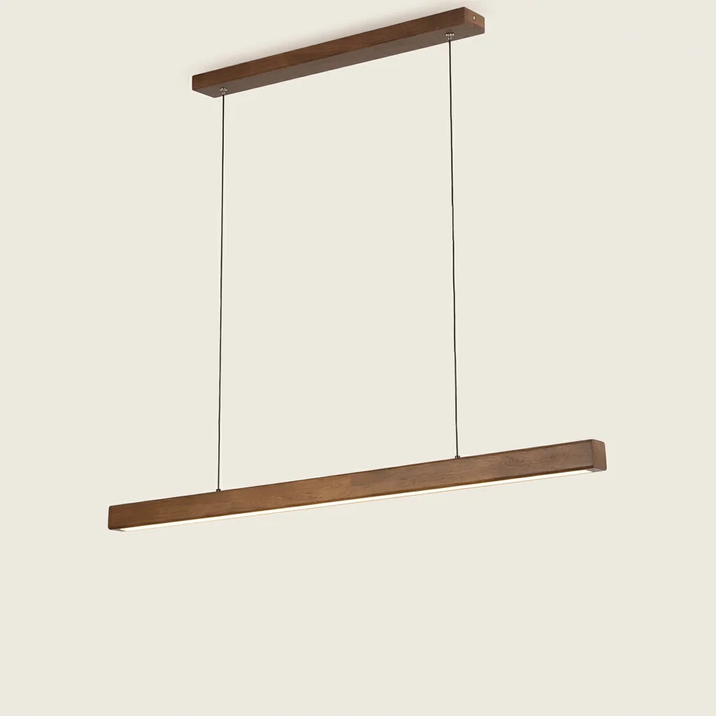Suspension barre LED en noyer allumée au-dessus d’une table