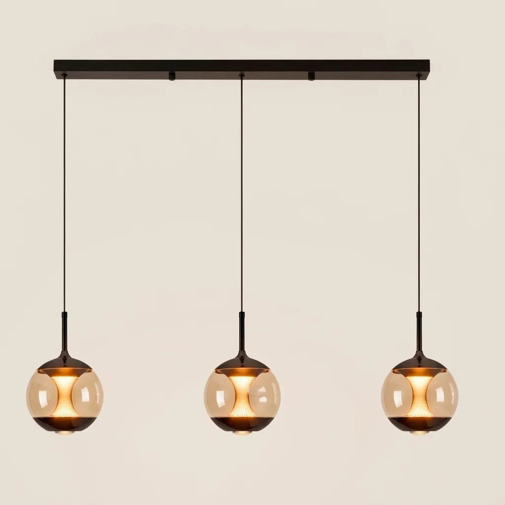 Suspension à 3 globes de verre ambré sur rail noir